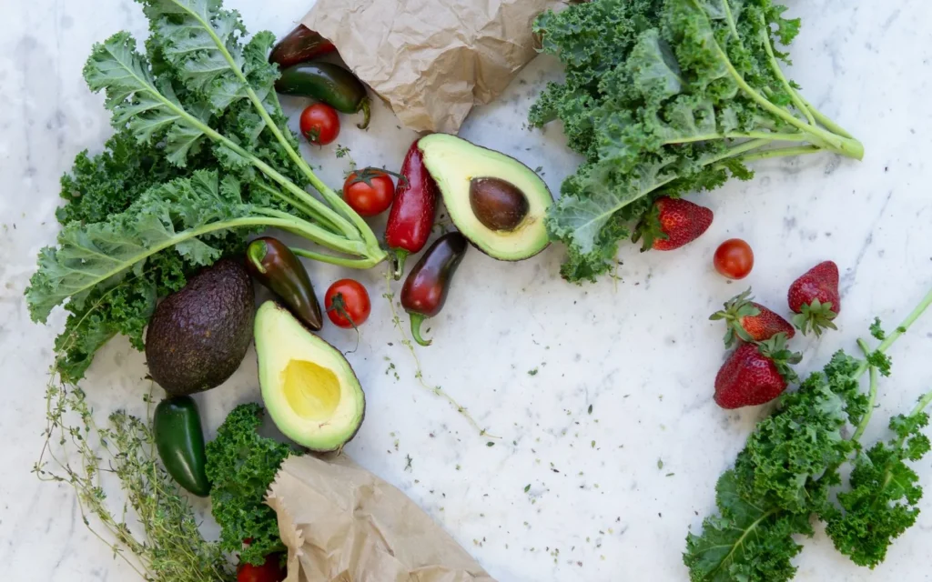 Verduras y aguacate sobre una mesa de mármol